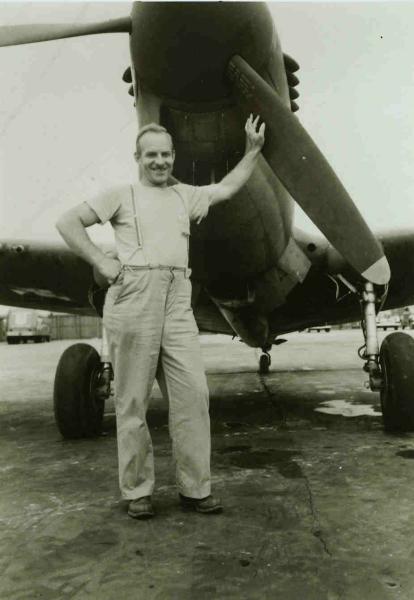 A picture of Harvey Yearke, standing under a P-40